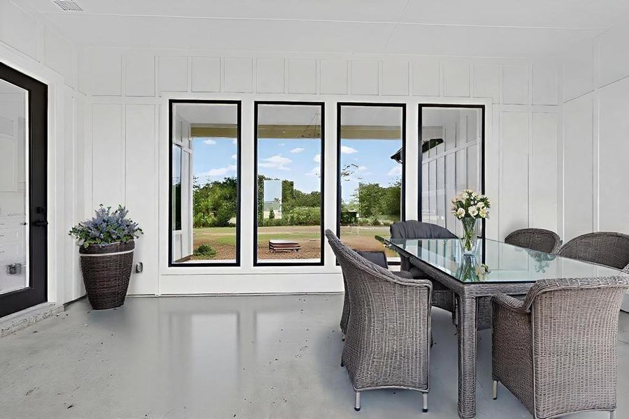 Dining room with a decorative wall, healthy amount of natural light, and finished concrete flooring Dining room with a decorative wall, healthy amount of natural light, and finished concrete flooring