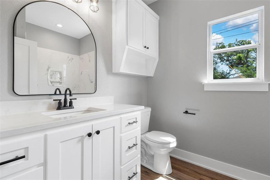 Bathroom with wood finished floors and vanity