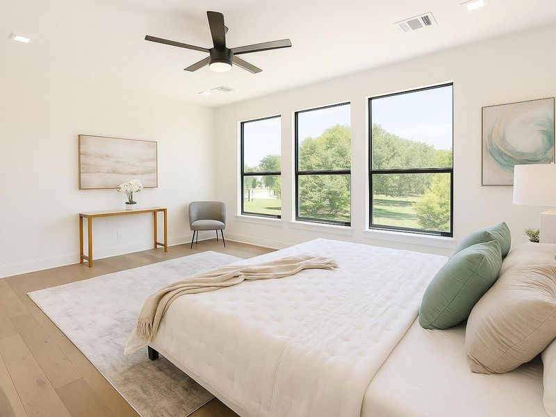 Spacious primary bedroom filled with natural light, featuring large windows, modern finishes, and a comfortable, elegant design.