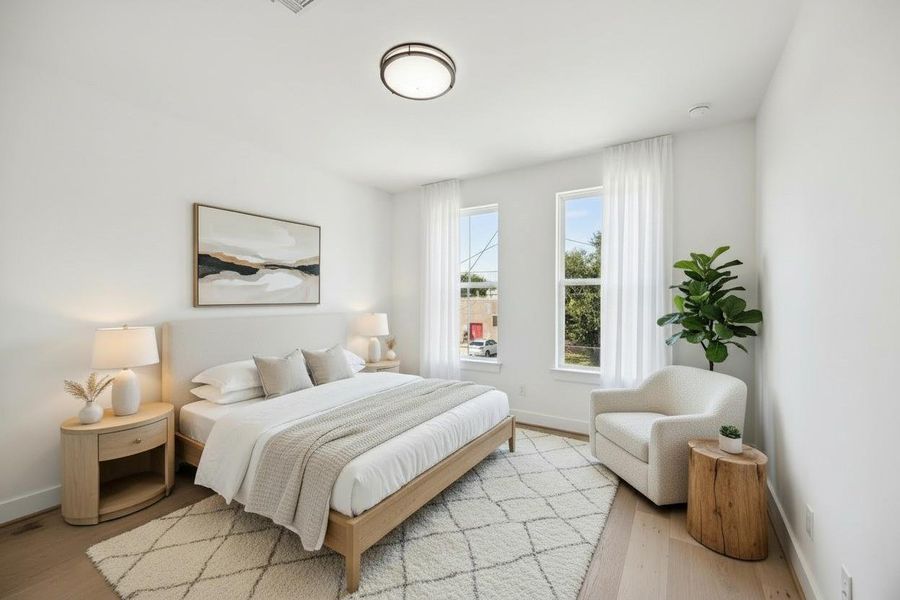 Comfortable guest room with high ceilings and large windows. Comfortable guest room with high ceilings and large windows.