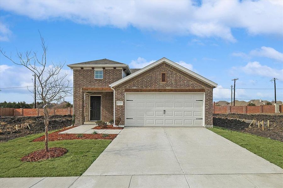 View of front of home with a front lawn and a garage