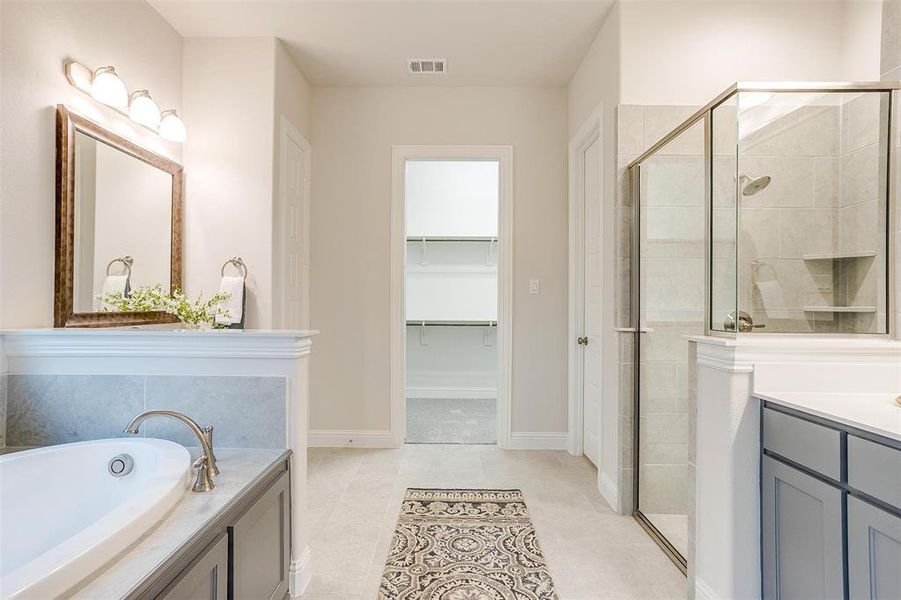 Bathroom with independent shower and bath, vanity, and tile patterned floors