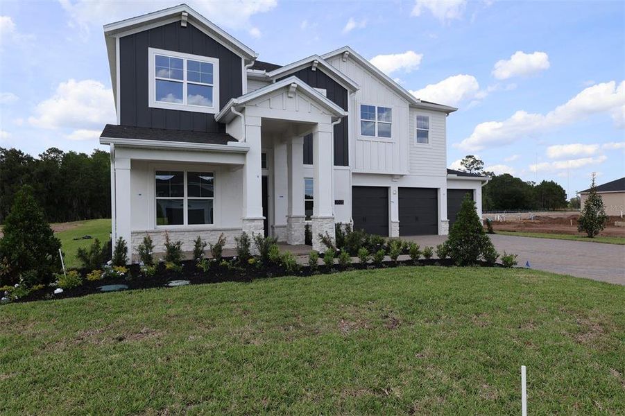 Front exterior of a new home in Solace at Corner Lake, Orlando, FL, highlighting curb appeal (Image 1). Front exterior of a new home in Solace at Corner Lake, Orlando, FL, highlighting curb appeal (Image 1).
