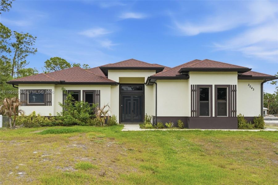Front exterior of a new home in , Naples, FL, highlighting curb appeal (Image 26).