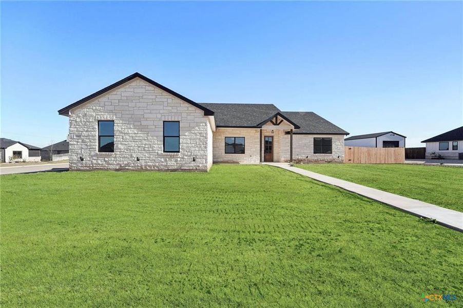 A graceful stone facade and a verdant lawn invite you to this appealing residence. A graceful stone facade and a verdant lawn invite you to this appealing residence.