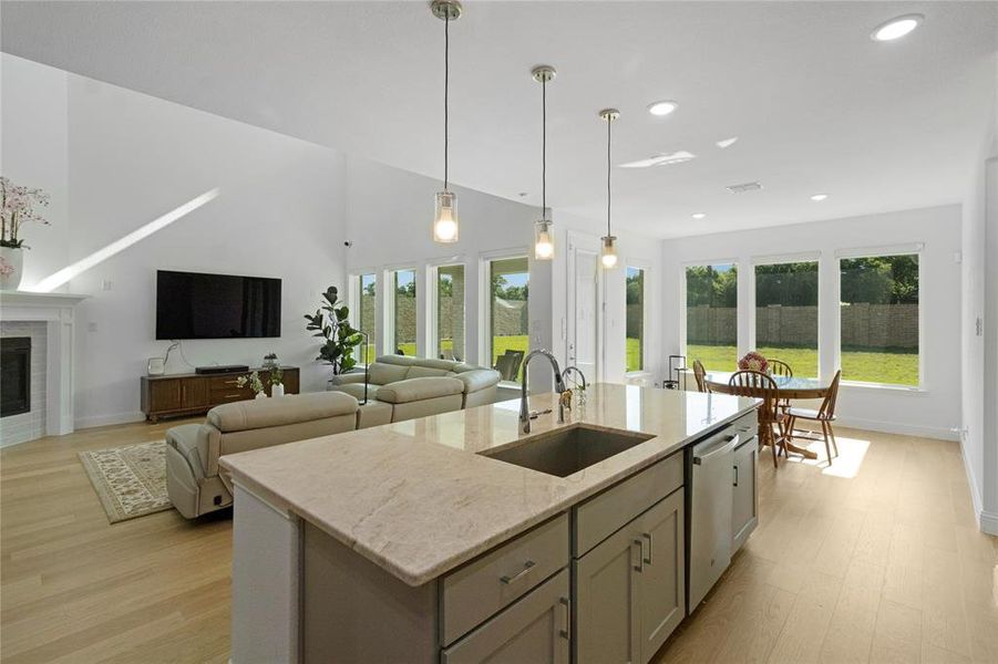 Open concept living area with vaulted ceilings and light wood-finish flooring