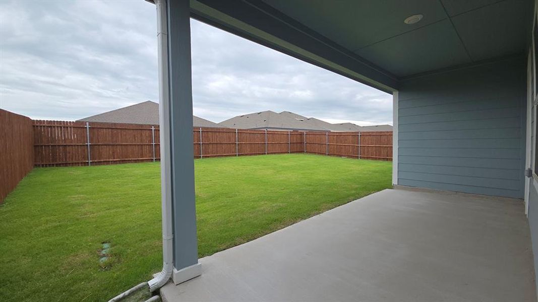 Covered patio with a concrete surface, providing exterior living space