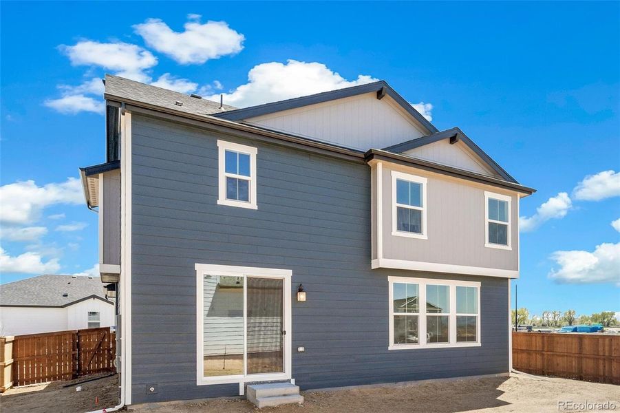 Front exterior of a new home in Farmlore, Brighton, CO, highlighting curb appeal (Image 22).