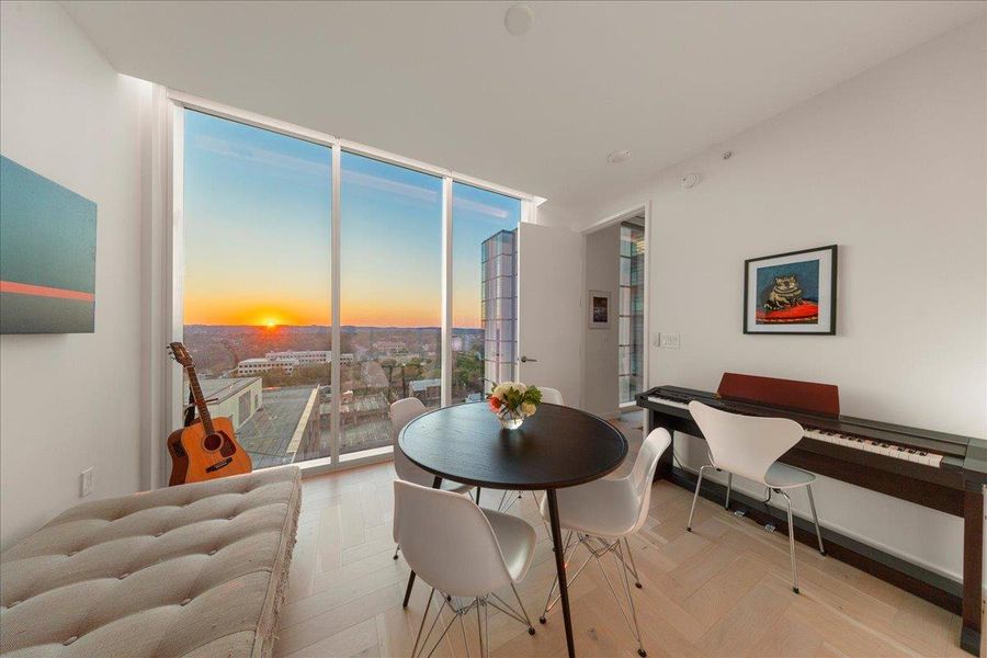 Bright and versatile second bedroom with floor-to-ceiling windows that capture breathtaking sunsets over the Hill Country. A flexible space that easily transitions into a guest room, home office, or creative retreat.