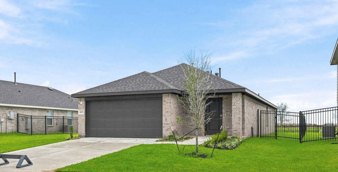 Front exterior of a new home in Sunterra, Katy, TX, highlighting curb appeal (Image 21).