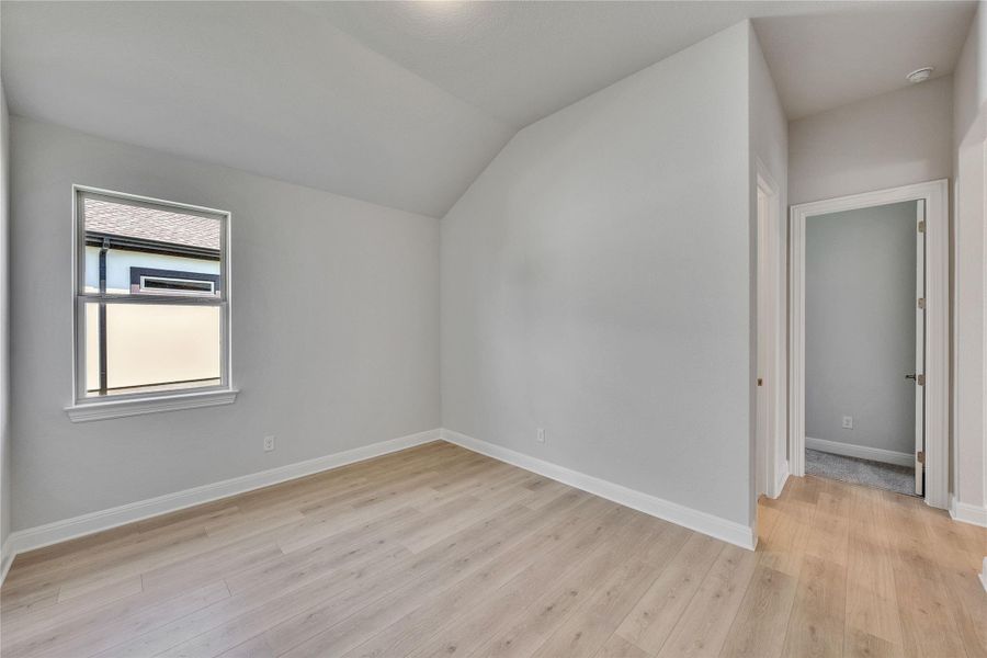 Bonus room featuring lofted ceiling and light wood finished floors Bonus room featuring lofted ceiling and light wood finished floors