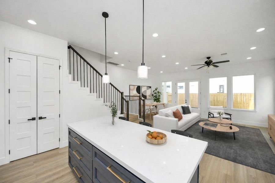 Open-concept kitchen and living area with a large island, modern finishes, and great natural light—ideal for entertaining and everyday living.