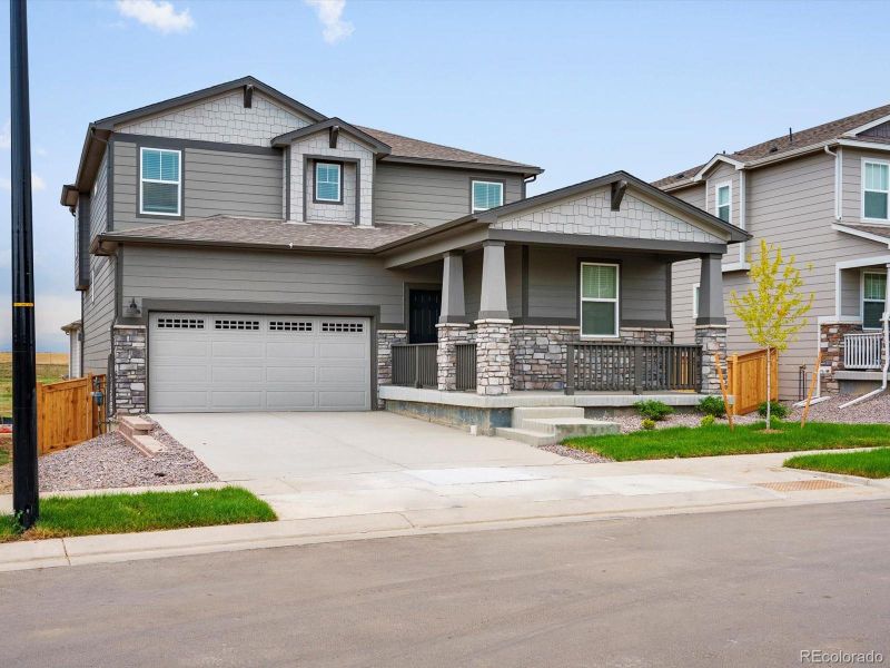 Front exterior of a new home in Buffalo Highlands: The Flora Collection, Commerce City, CO, highlighting curb appeal (Image 2). Front exterior of a new home in Buffalo Highlands: The Flora Collection, Commerce City, CO, highlighting curb appeal (Image 2).