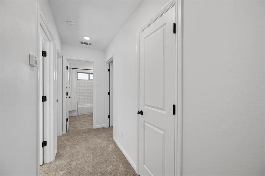 Hallway with light colored carpet