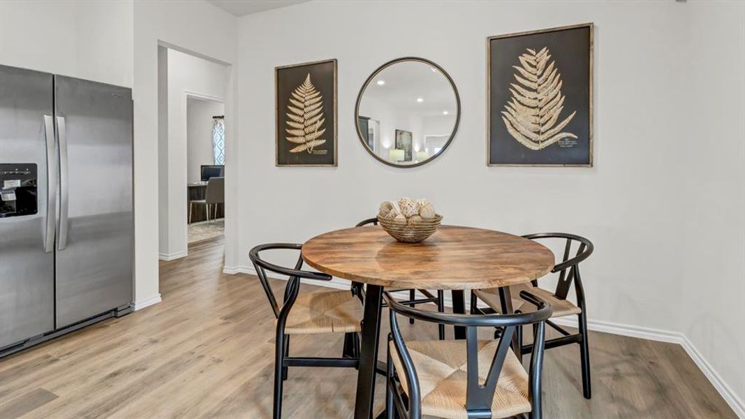 Dining room with light wood-type flooring and recessed lighting Dining room with light wood-type flooring and recessed lighting