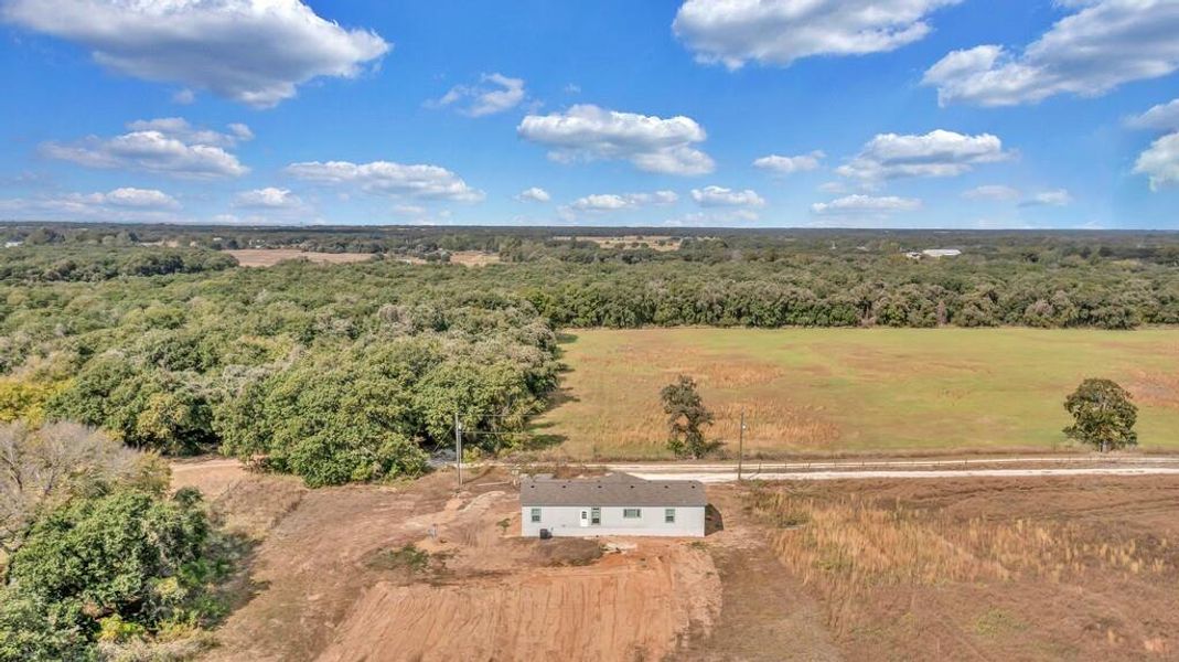 View from above of property with a heavily wooded area View from above of property with a heavily wooded area