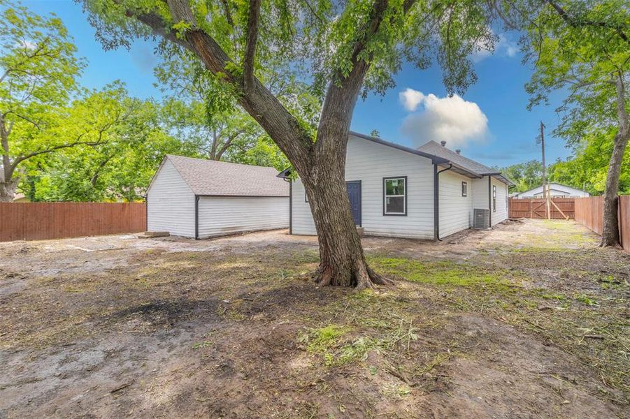 View of side of home featuring a fenced backyard and central AC View of side of home featuring a fenced backyard and central AC