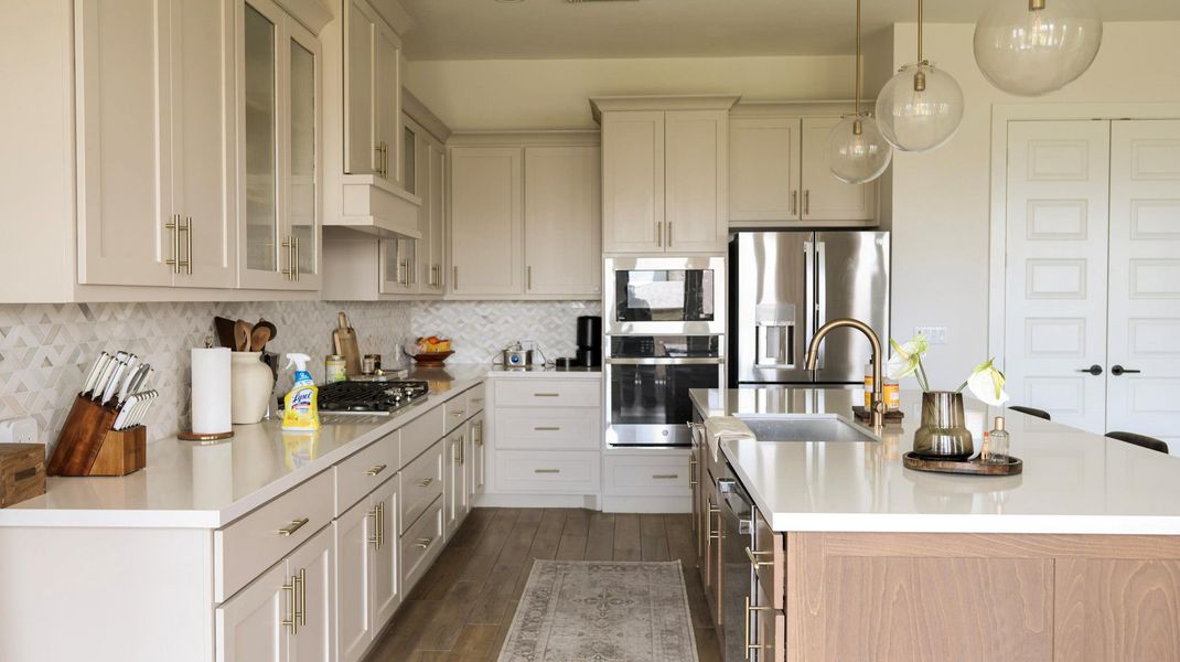 Culinary aspirations find their home in this well-appointed kitchen featuring light cabinetry and modern fixtures. Culinary aspirations find their home in this well-appointed kitchen featuring light cabinetry and modern fixtures.