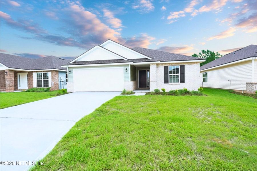 Front exterior of a new home in Summerglen, Jacksonville, FL, highlighting curb appeal (Image 1). Front exterior of a new home in Summerglen, Jacksonville, FL, highlighting curb appeal (Image 1).