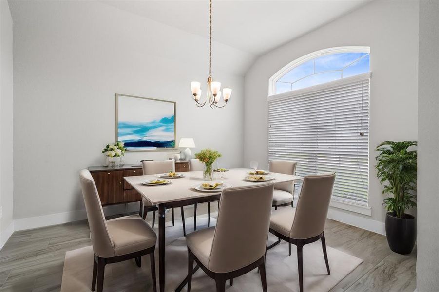 Make memories gathered around the table with your family and friends! This dining room features high ceilings, large windows, wood look tile and a beautiful chandelier.