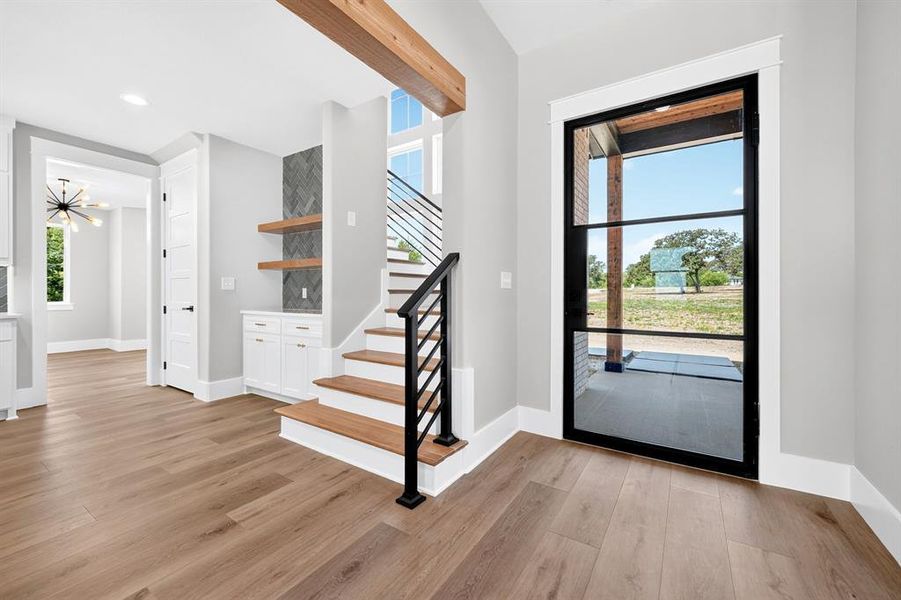 A striking pivot style glass door that makes a bold first impression. A striking pivot style glass door that makes a bold first impression.