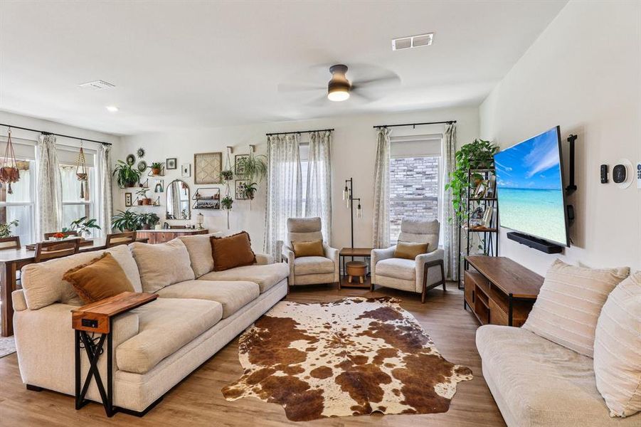 Living room with wood finished floors and a ceiling fan Living room with wood finished floors and a ceiling fan