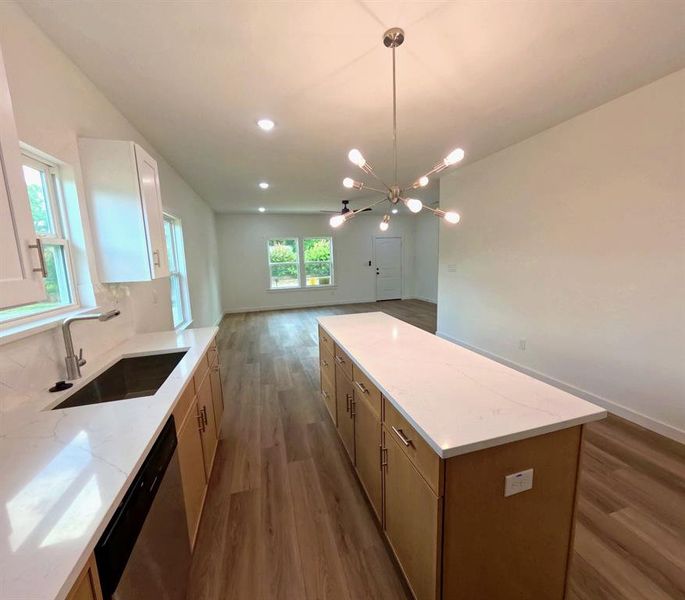 Kitchen with a kitchen island, open floor plan, dark wood-style floors, stainless steel dishwasher, and recessed lighting Kitchen with a kitchen island, open floor plan, dark wood-style floors, stainless steel dishwasher, and recessed lighting