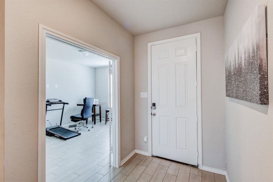 Foyer entrance with baseboards and light wood-style floors Foyer entrance with baseboards and light wood-style floors
