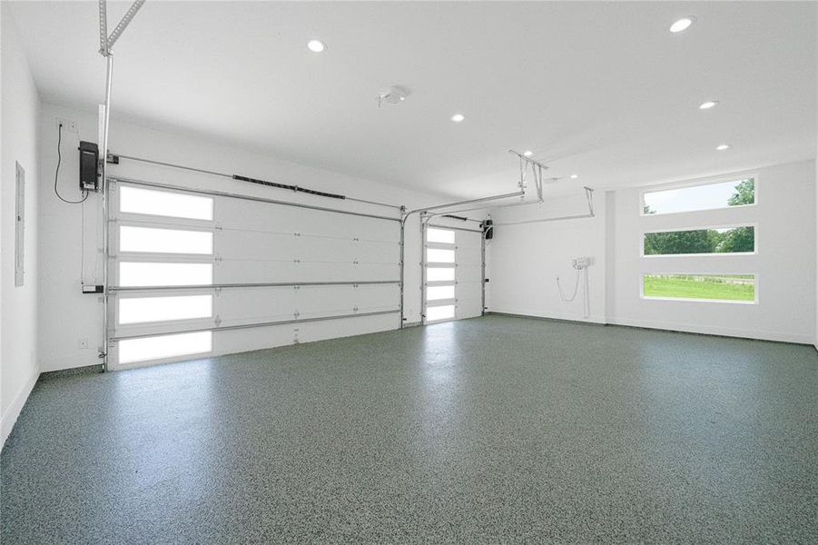 Garage with recessed lighting and electric panel