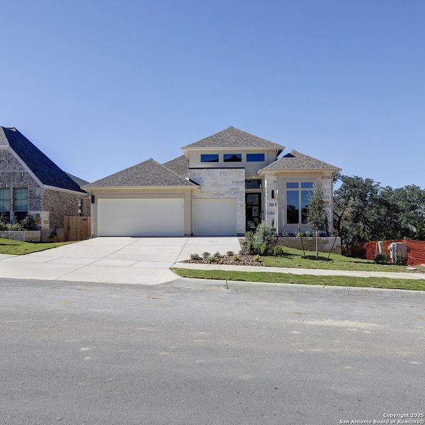 Front exterior of a new home in Ranches At Creekside 55', Boerne, TX, highlighting curb appeal (Image 1). Front exterior of a new home in Ranches At Creekside 55', Boerne, TX, highlighting curb appeal (Image 1).