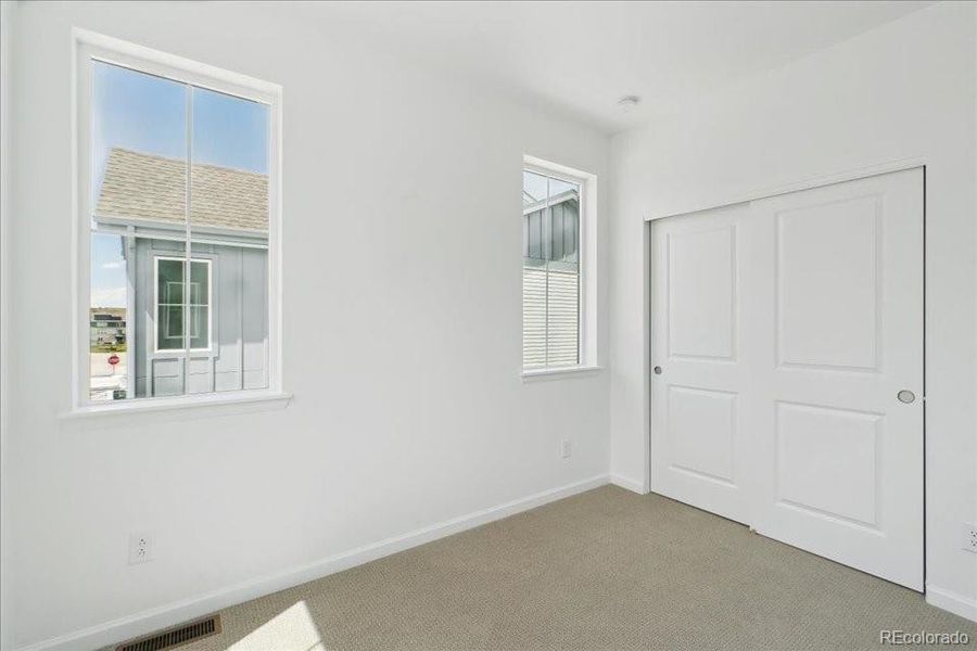 Spacious, unfurnished interior of a new home in Pacific Collection at The Townes at Skyline Ridge, Castle Pines (Image 13).