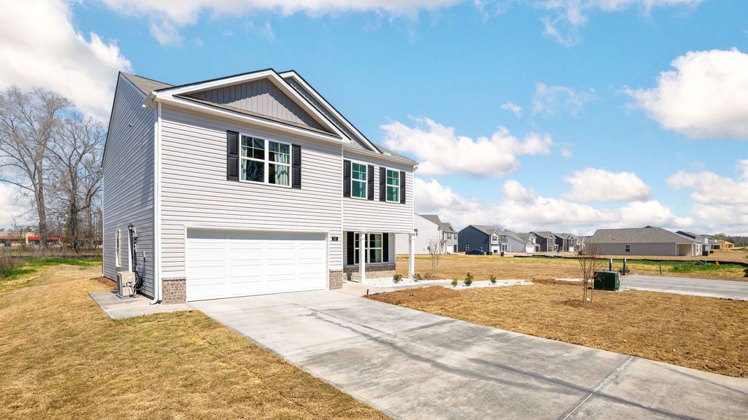 Front exterior of a new home in Powell Meadows, Cleveland, TN, highlighting curb appeal (Image 20). Front exterior of a new home in Powell Meadows, Cleveland, TN, highlighting curb appeal (Image 20).