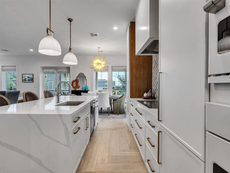 Cooking becomes an experience here — surrounded by high-end Café appliances, a Monogram cooktop, and soft-close cabinetry that blends beauty with function. The herringbone wood-look tile and custom finishes invite you to linger and enjoy every moment spent preparing meals with loved ones. Cooking becomes an experience here — surrounded by high-end Café appliances, a Monogram cooktop, and soft-close cabinetry that blends beauty with function. The herringbone wood-look tile and custom finishes invite you to linger and enjoy every moment spent preparing meals with loved ones.