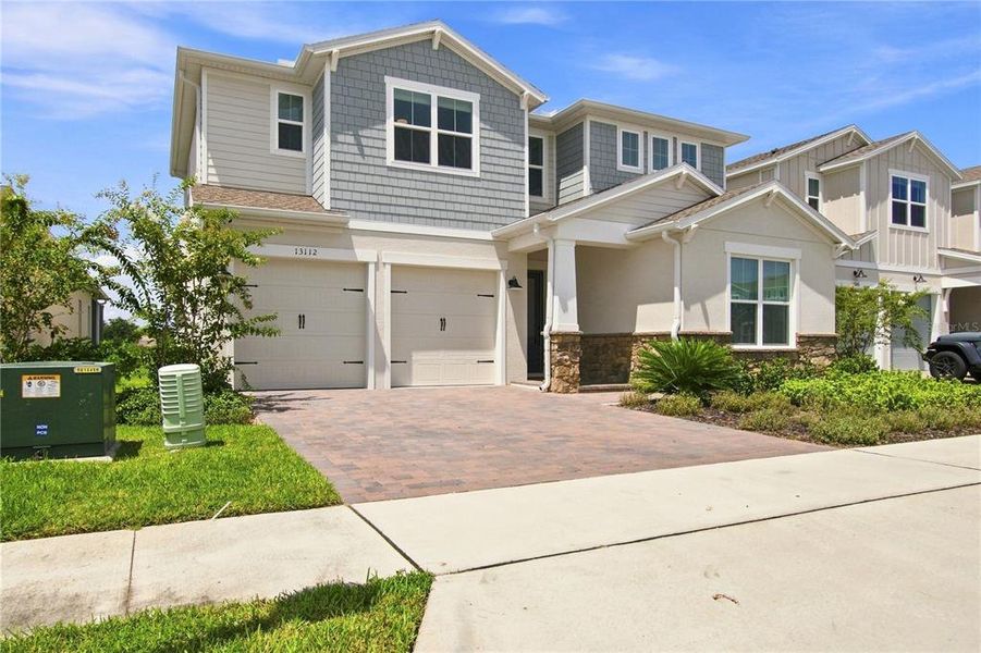 Front exterior of a new home in Horizon Isle, Winter Garden, FL, highlighting curb appeal (Image 28). Front exterior of a new home in Horizon Isle, Winter Garden, FL, highlighting curb appeal (Image 28).