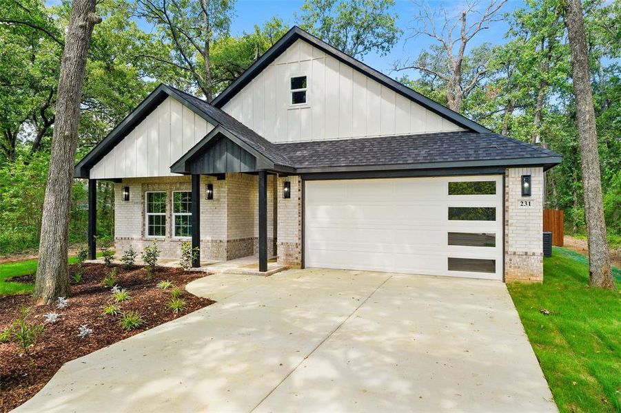 Contemporary-style exterior featuring light-colored brick and white vertical siding Contemporary-style exterior featuring light-colored brick and white vertical siding