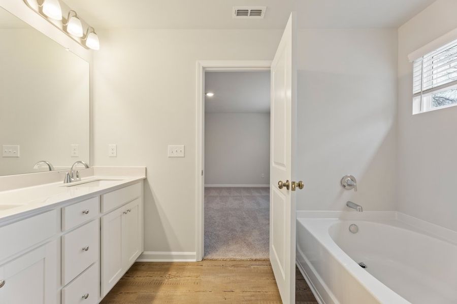 A bathroom with a tub and sink.