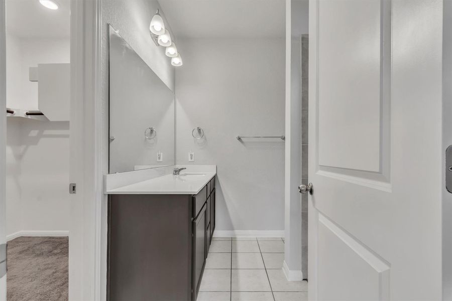 A well-lit bathroom vanity with modern fixtures and ample counter space.