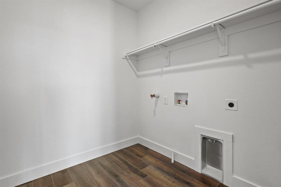 Laundry room featuring hookup for a gas dryer, hookup for an electric dryer, washer hookup, and dark hardwood / wood-style flooring