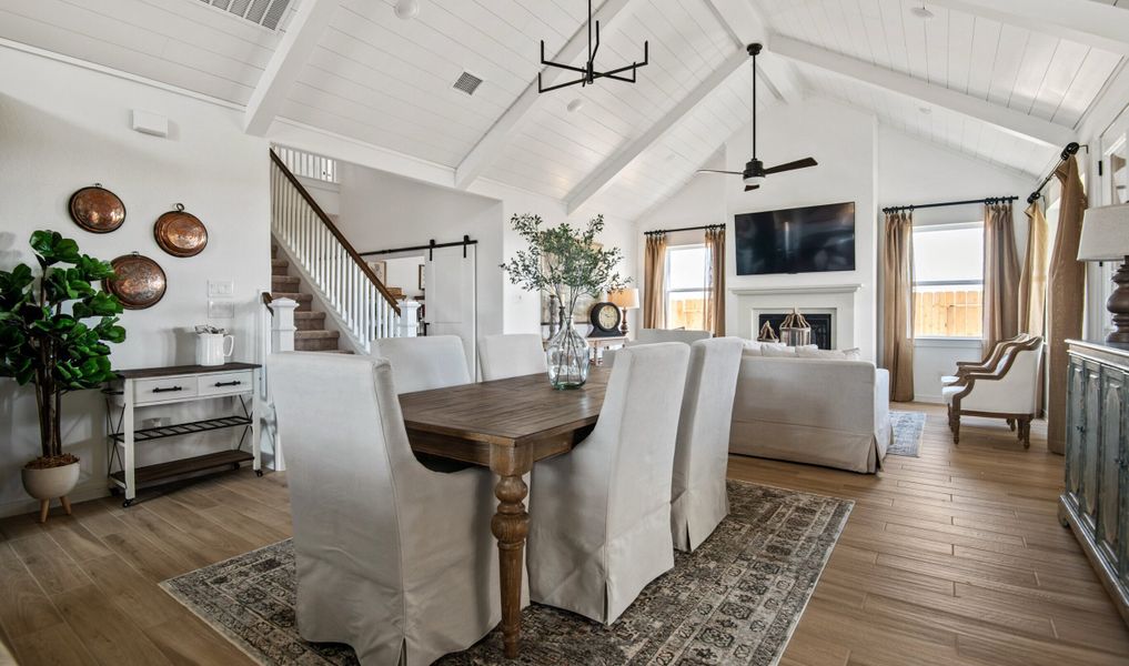 Dining area with vaulted ceiling and white painted ceiling beams Dining area with vaulted ceiling and white painted ceiling beams