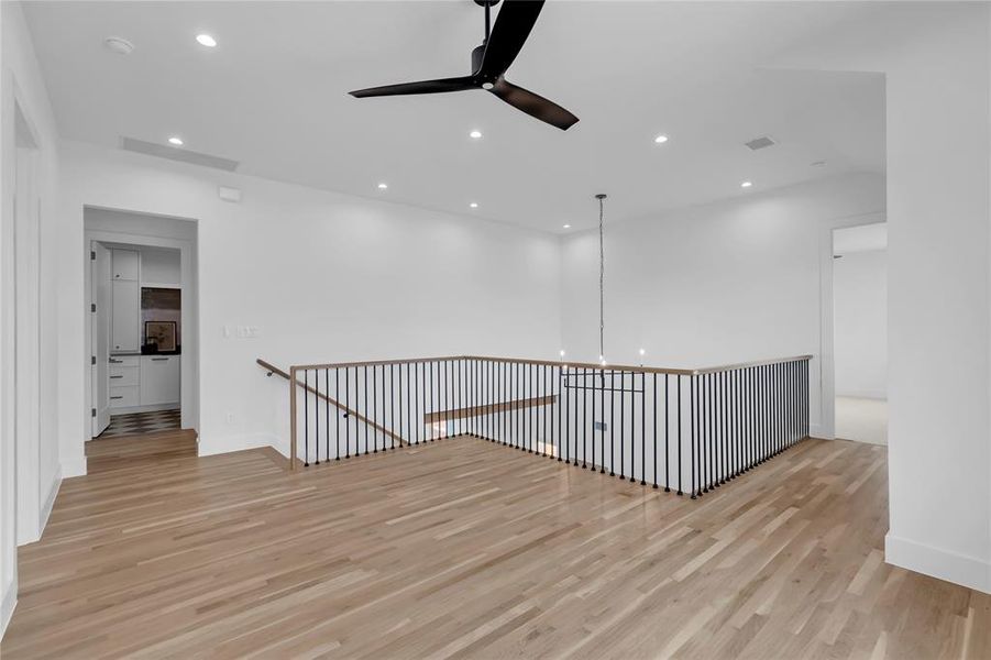 Unfurnished room featuring ceiling fan, light wood finished floors, and recessed lighting Unfurnished room featuring ceiling fan, light wood finished floors, and recessed lighting