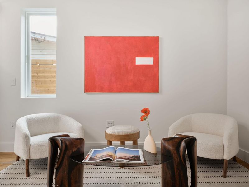 Living area featuring baseboards and wood finished floors Living area featuring baseboards and wood finished floors