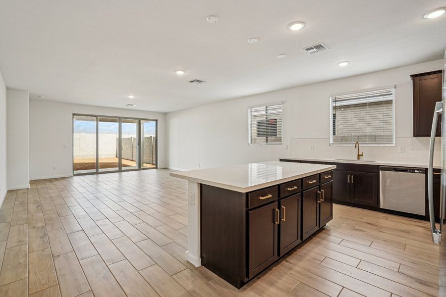 Kitchen, dining and great room. Finishes may vary by community.