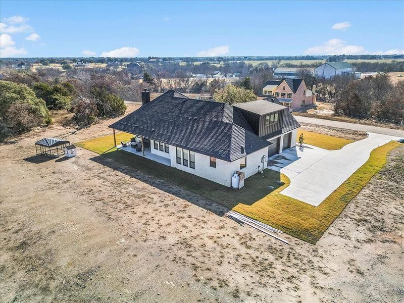 Birds eye view of property facing southeast towards back of neighborhood and towards downtown Weatherford.