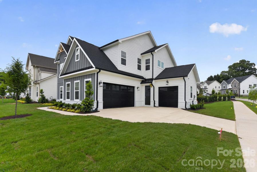 Front exterior of a new home in Coventry Glen, Huntersville, NC, highlighting curb appeal (Image 2). Front exterior of a new home in Coventry Glen, Huntersville, NC, highlighting curb appeal (Image 2).