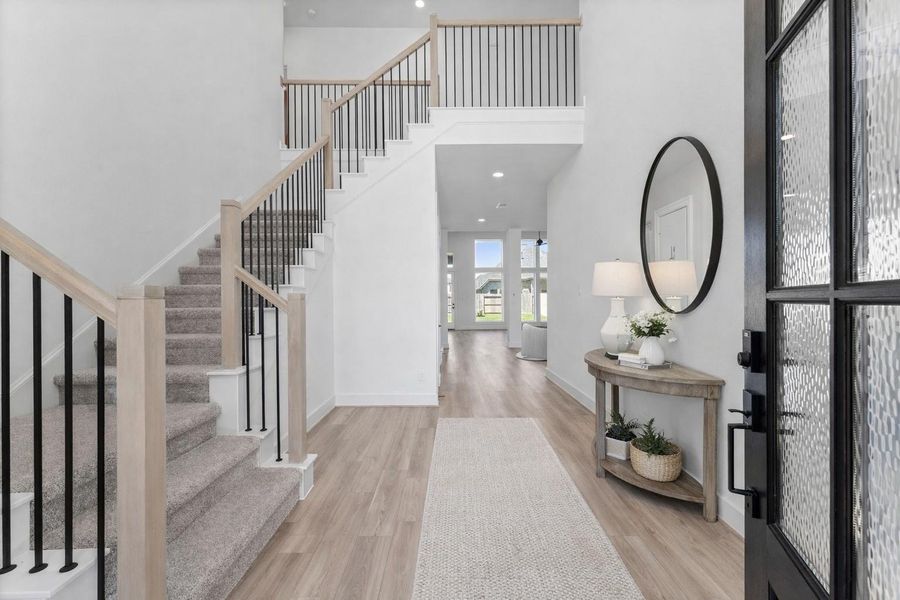 Elegant two-story entry with stunning staircase, virtually staged for your vision. Elegant two-story entry with stunning staircase, virtually staged for your vision.