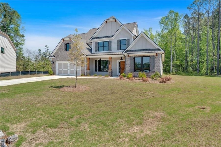 Front exterior of a new home in Springside Reserve, Powder Springs, GA, highlighting curb appeal (Image 1). Front exterior of a new home in Springside Reserve, Powder Springs, GA, highlighting curb appeal (Image 1).