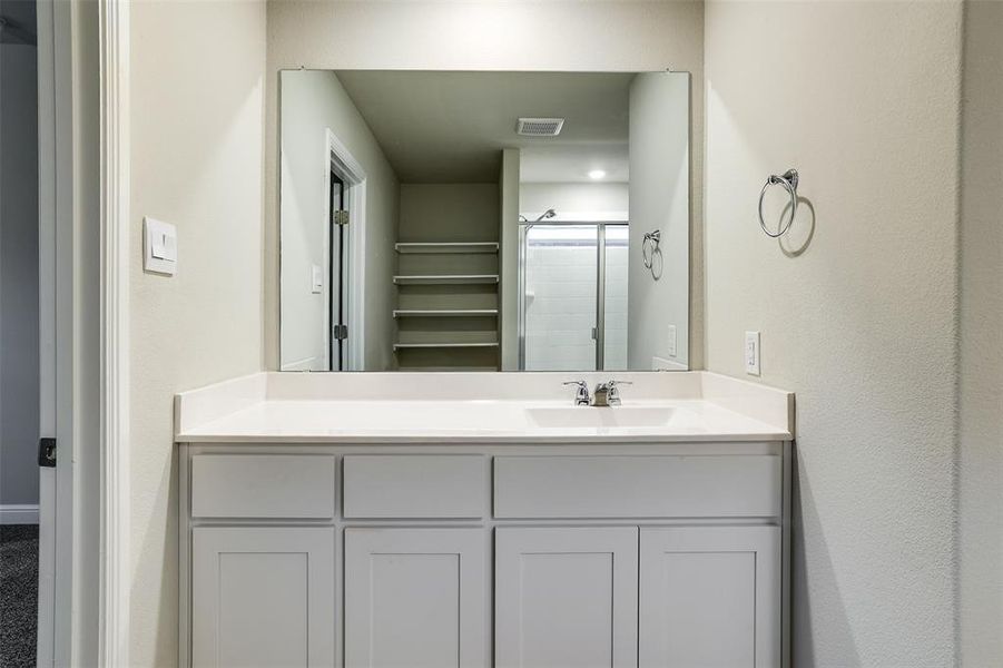 Bathroom with a stall shower and vanity Bathroom with a stall shower and vanity