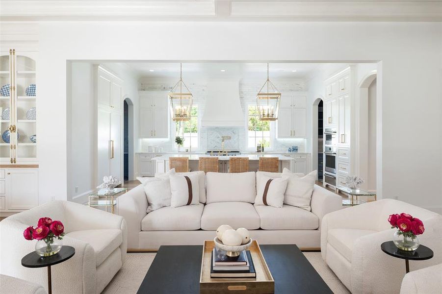 Living room featuring sink and a notable chandelier