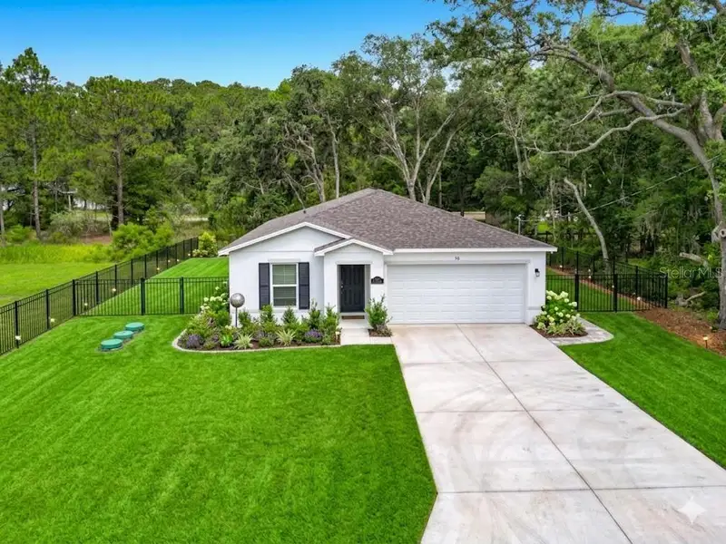 Front exterior of a new home in The Collection at Ocklawaha, Ocklawaha, FL, highlighting curb appeal (Image 1). Front exterior of a new home in The Collection at Ocklawaha, Ocklawaha, FL, highlighting curb appeal (Image 1).