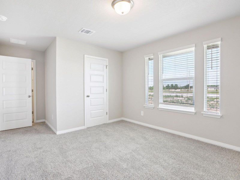 Empty room with carpet floors and baseboards Empty room with carpet floors and baseboards